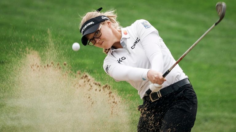 Canada's Brooke Henderson hits out of the sand on the...