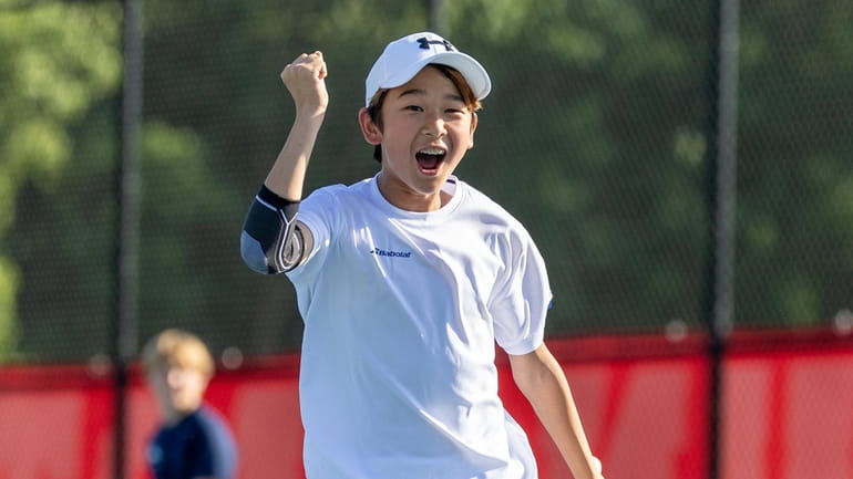 Hudson Lee of Friends Academy pumps his fist after hitting...