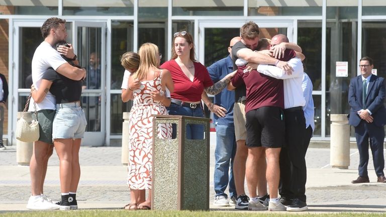 An emotional scene unfolds Friday outside of First District Court...