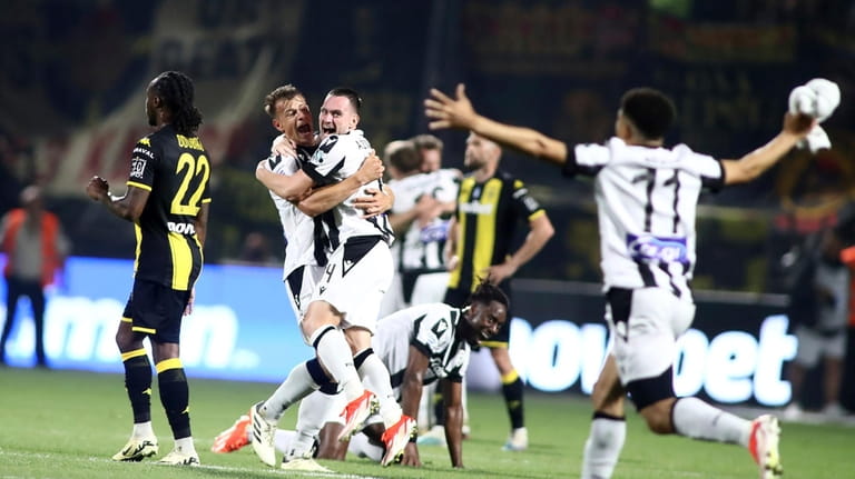 PAOK's players celebrate winning the Greek Super League soccer championship...