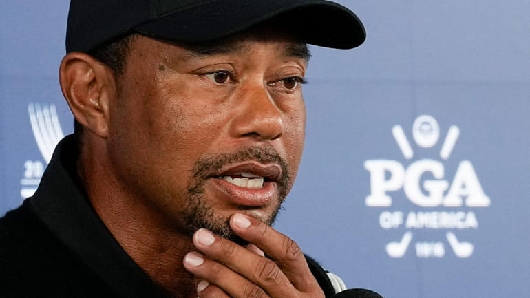 Tiger Woods speaks during a news conference at the PGA...