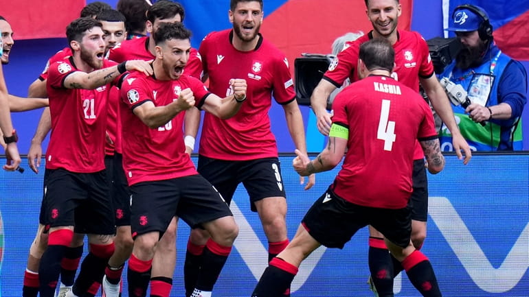 Georgia players celebrate after Georges Mikautadze scored the opening goal...