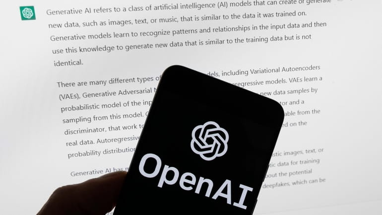The OpenAI logo is seen on a mobile phone in...