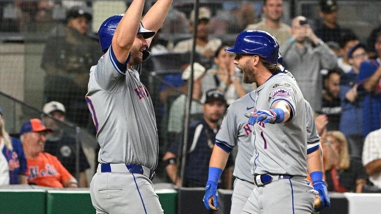 The Mets’ Pete Alonso greets Jeff McNeil after his two-run...