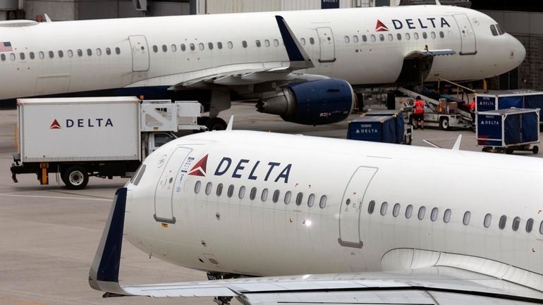 A Delta Air Lines plane leaves the gate, July 12,...