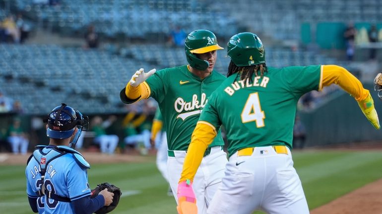 Oakland Athletics' JJ Bleday, center, celebrates with Lawrence Butler (4)...