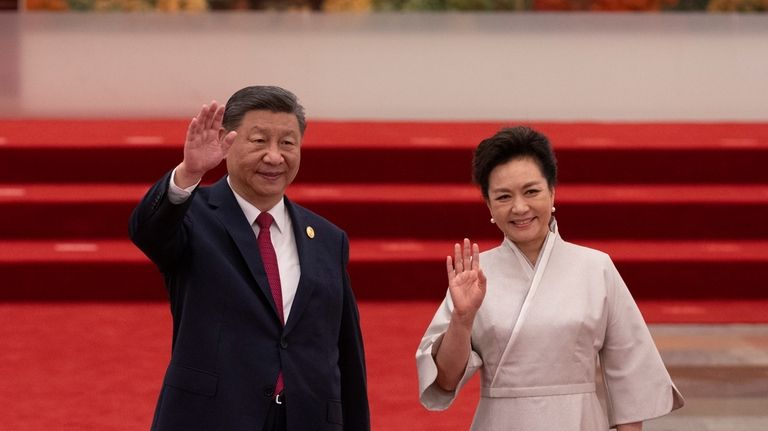 China's President Xi Jinping and his wife, Peng Liyuan, greet...