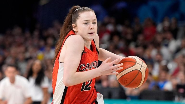 Canada's Syla Swords drives toward the basket during a women's...