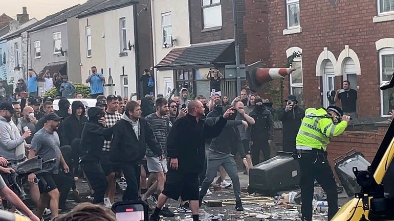 An unruly crowd clash with police, Tuesday, July 30, 2024,...