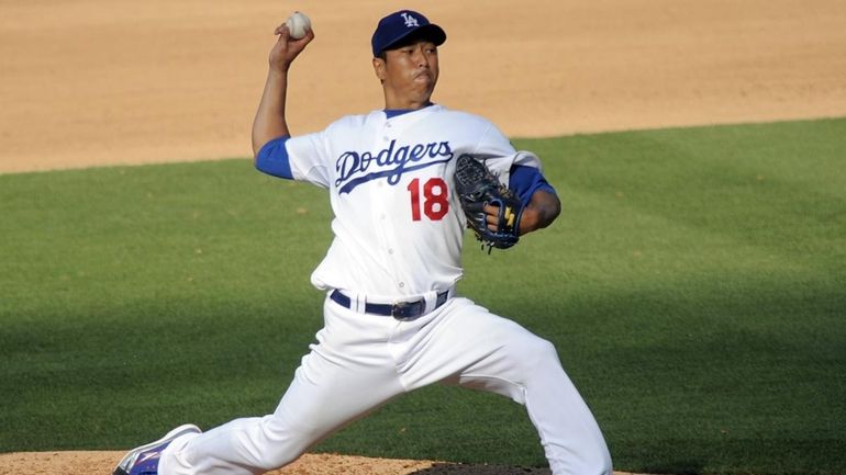 Los Angeles Dodgers starting pitcher Hiroki Kuroda of Japan throws...