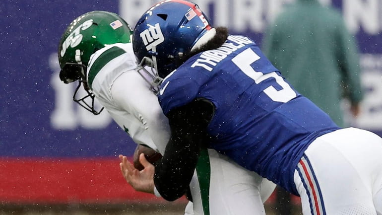 Kayvon Thibodeaux of the Giants sacks Zach Wilson of the Jets during...
