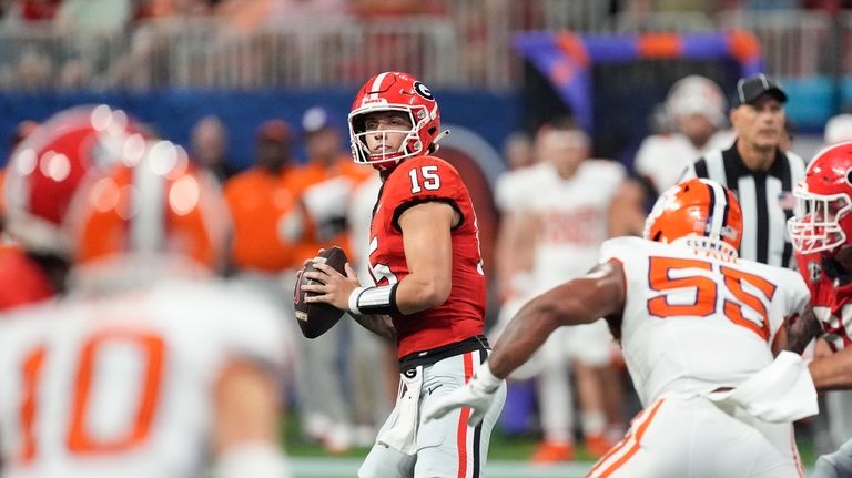 Georgia quarterback Carson Beck (15) throws from the pocket during...