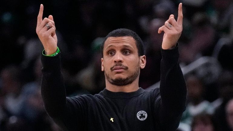 Boston Celtics head coach Joe Mazzulla calls to his players...