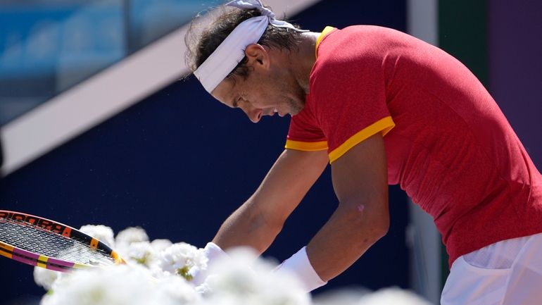 Spain's Rafael Nadal reacts as he plays Serbia's Novak Djokovic...