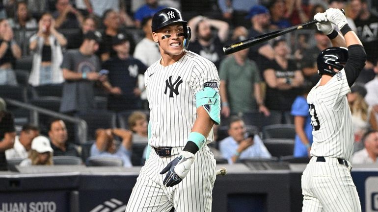 Yankees centerfielder Aaron Judge returns to the dugout after striking...