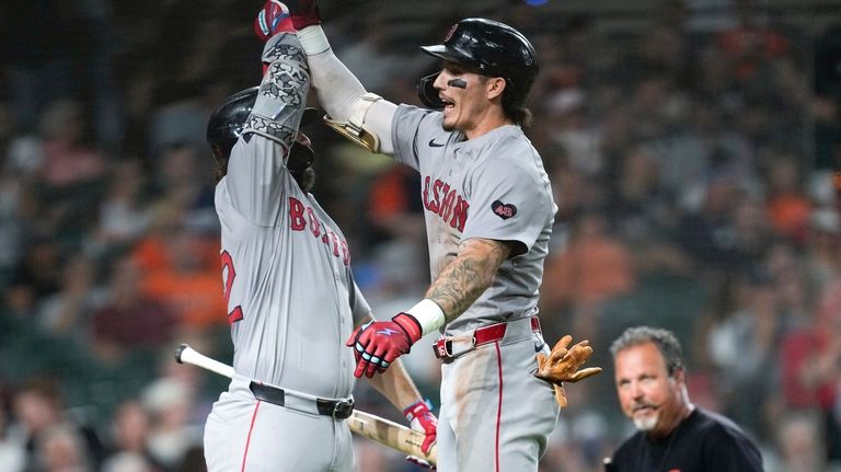 Boston Red Sox's Jarren Duran, right, celebrates his home run...