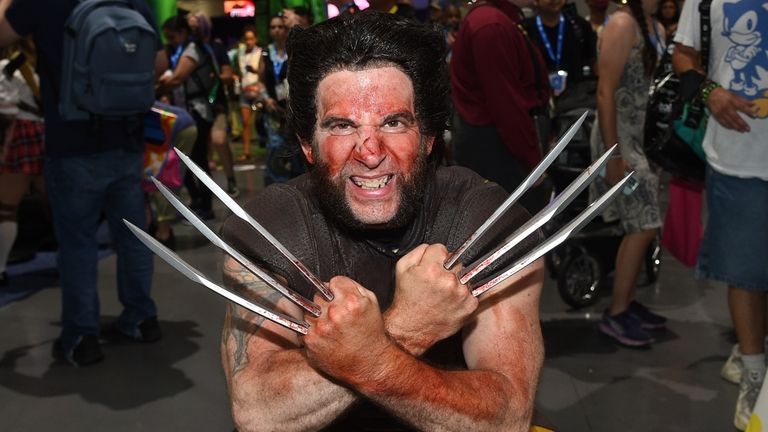 A fan dressed as Wolverine poses at Comic-Con International on...