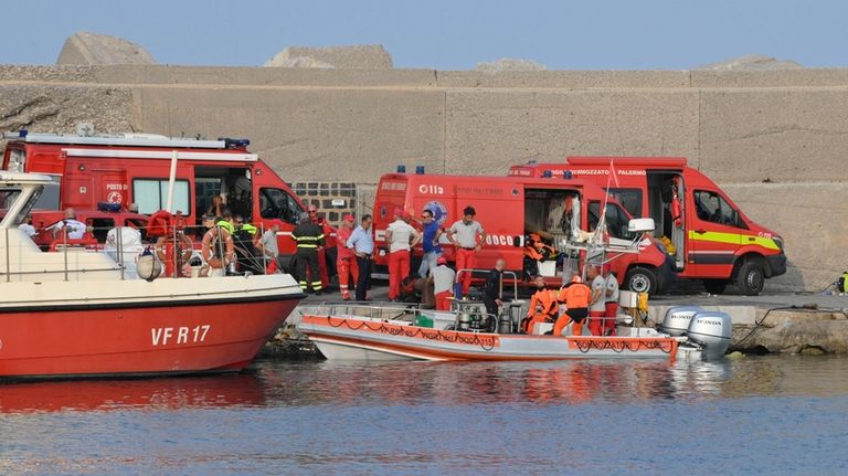 Italian Firefighters scubadivers prepare to sail toward the area where...