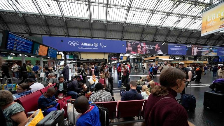 Travellers wait at the Gare de L'Est at the 2024...