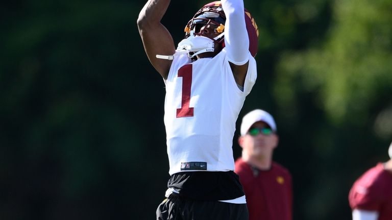 Washington Commanders wide receiver Jahan Dotson (1) works out during...