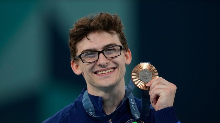 Stephen Nedoroscik, of the U.S., celebrates after winning the bronze...