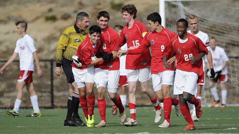 Friends Academy's Oliver Muran, third from left, celebrates with teammates...