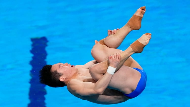 Wang Zongyuan, of China, competes during the men's 3-meter springboard...