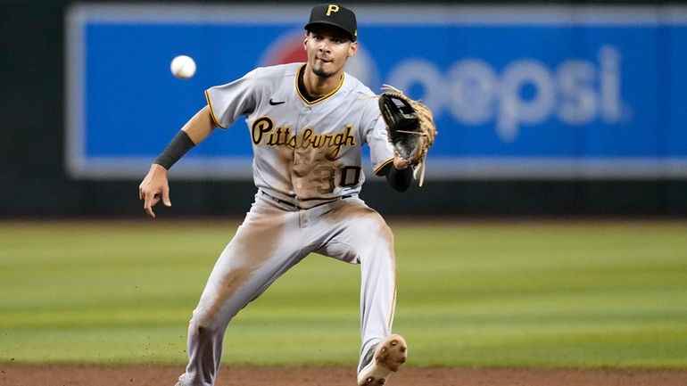 Pittsburgh Pirates shortstop Tucupita Marcano takes a throw down to...