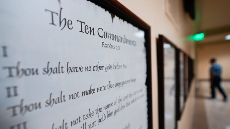 A copy of the Ten Commandments is posted along with...
