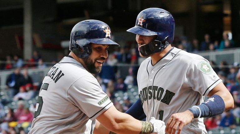 Houston Astros' Carlos Beltran, left, and Carlos Correa celebrate Beltran's...