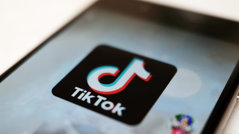 The TikTok logo is displayed on a smartphone screen, Sept....