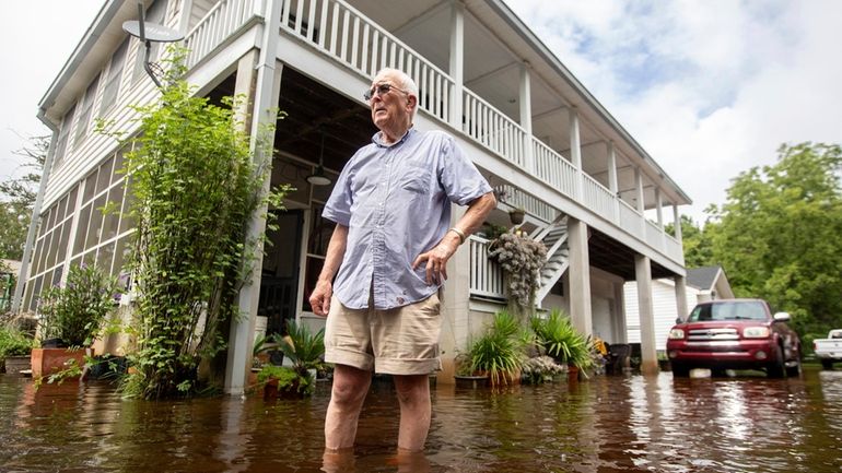 Charles Grainger cleans up around his house in the historic...