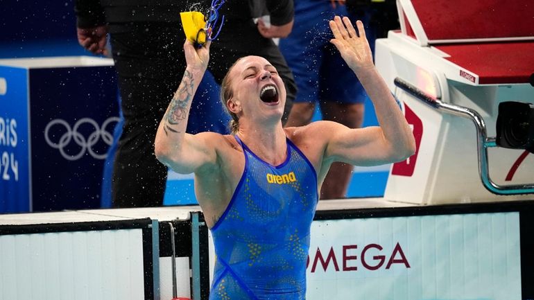 Sarah Sjoestroem, of Sweden, celebrates after winning the women's 100-meter...