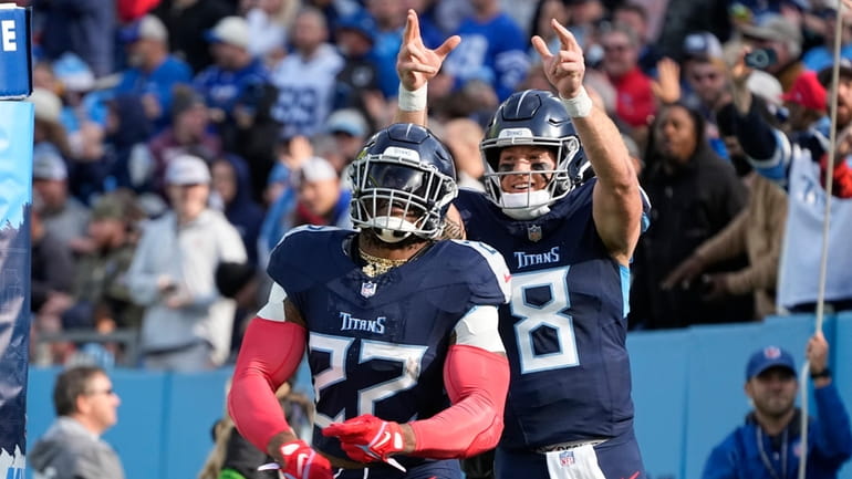Tennessee Titans' Derrick Henry (22) celebrates with quarterback Will Levis...