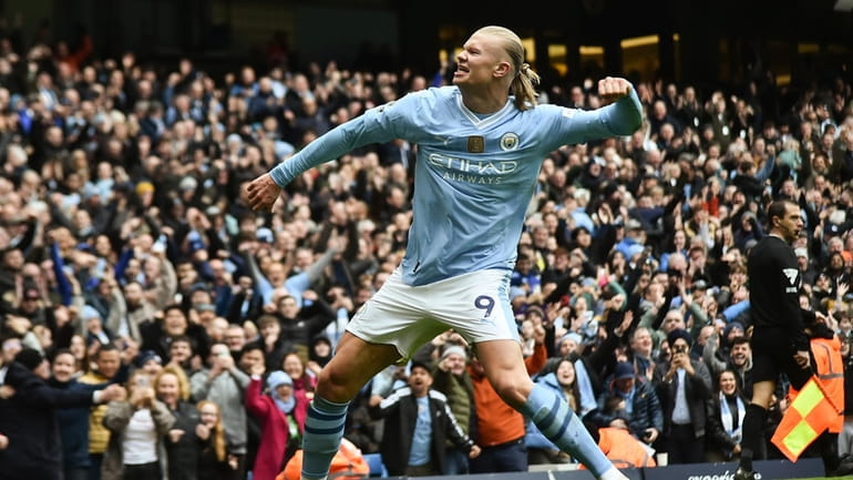 Manchester City's Erling Haaland celebrates with after scoring his side's...