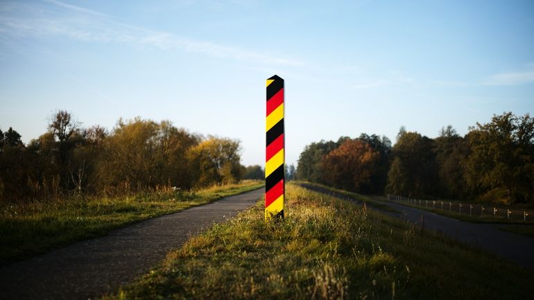 A border pole in German national colours marking the German...