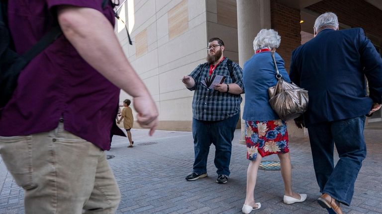 Dave Mitchell, of Houston, Texas, distributes brochures to promote the...