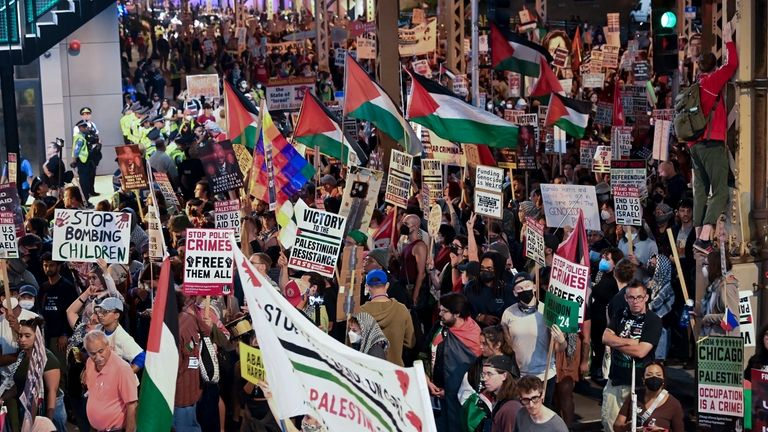 Protesters march during a demonstration outside the Democratic National Convention...