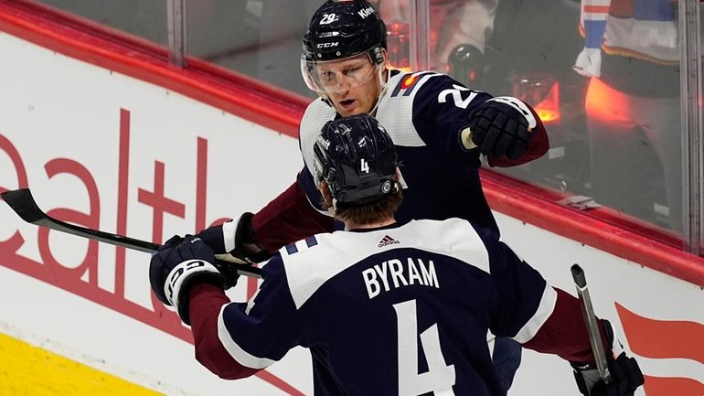 Colorado Avalanche defenseman Bo Byram (4) congratulates center Nathan MacKinnon,...