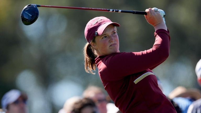 Lottie Woad, of England, watches her tee shot on the...