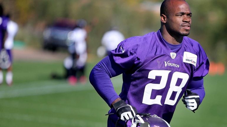 Minnesota Vikings running back Adrian Peterson makes his way off...