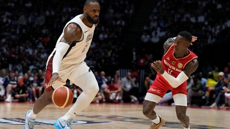 United States' forward LeBron James, left, and Germany's guard Dennis...