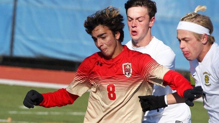 Half Hollow Hills West's Zachary Dahl, left, takes a shot...