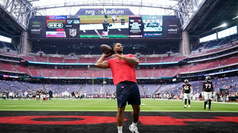 Houston Texans running back Joe Mixon throws a football before...