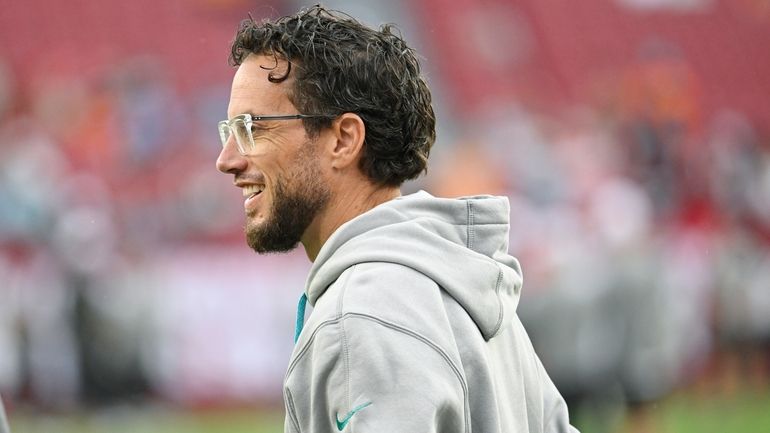 Miami Dolphins head coach Mike McDaniel watches the team before...