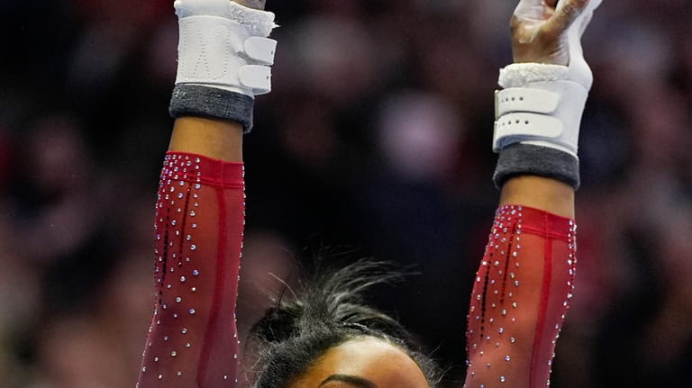Simone Biles competes on the uneven bars at the United...