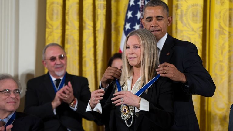 President Barack Obama, right, presents the Presidential Medal of Freedom...