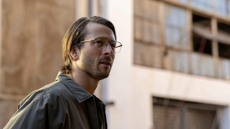 This image released by Netflix shows Glen Powell in a...