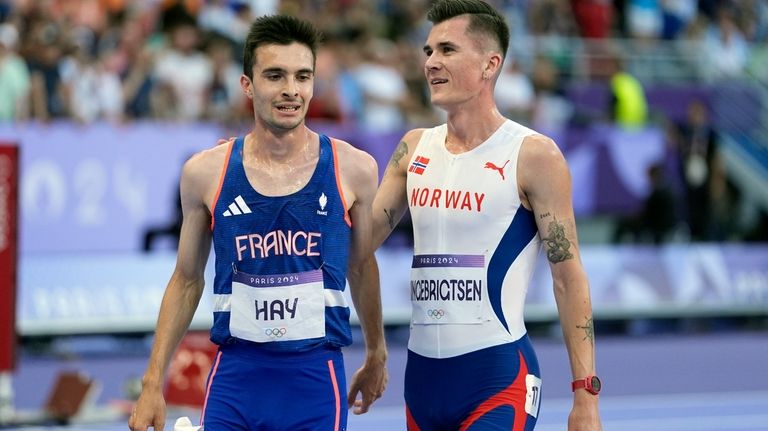 Jakob Ingebrigtsen, right, of Norway, is congratulated by Hugo Hay,...