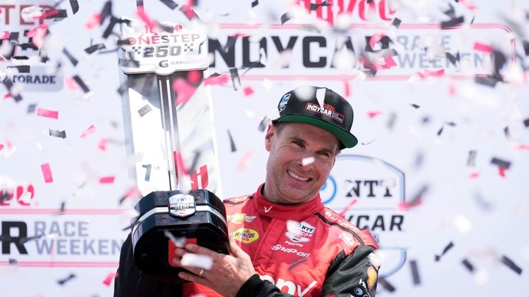 Will Power celebrates after winning an IndyCar auto race, Sunday,...